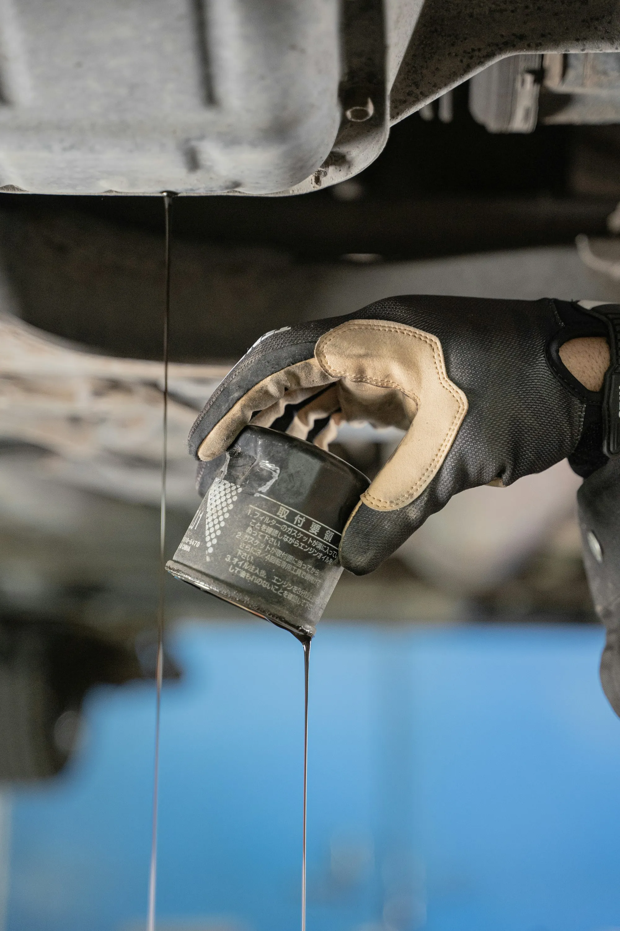 Golden motor oil dripping into an engine